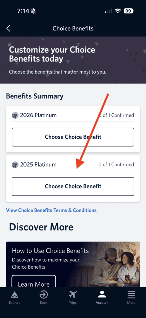 The image is a screenshot of a mobile app interface for managing "Choice Benefits." It shows a section titled "Benefits Summary" with options to choose benefits for "2026 Platinum" and "2025 Platinum," both showing "0 of 1 Confirmed." There is a red arrow pointing to the "2025 Platinum" option. Below, there is a section titled "Discover More" with a prompt to learn how to use Choice Benefits, accompanied by an image of a couple sitting together. The bottom navigation bar includes icons for Explore, Book, Trips, Account, and More.
