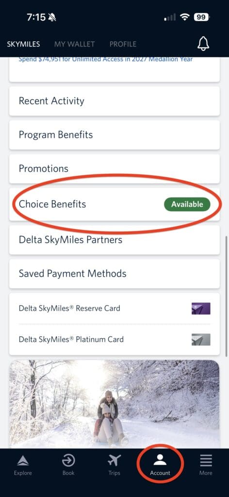 The image shows a mobile app interface for managing Delta SkyMiles. The top section displays the time and status icons. Below, there are menu options like "Recent Activity," "Program Benefits," "Promotions," and "Choice Benefits," with "Choice Benefits" highlighted and marked as "Available." Other options include "Delta SkyMiles Partners" and "Saved Payment Methods," with card options listed. At the bottom, there is a navigation bar with icons for "Explore," "Book," "Trips," "Account," and "More," with "Account" highlighted. A background image shows two people sledding in a snowy landscape.