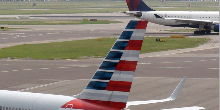 View Of American Airlines,Delta Air Lines Passenger Airplane Taxiing To Take Off From Amsterdam Schiphol International Airport In The Netherlands Europe.Including KLM Office Building Exterior
