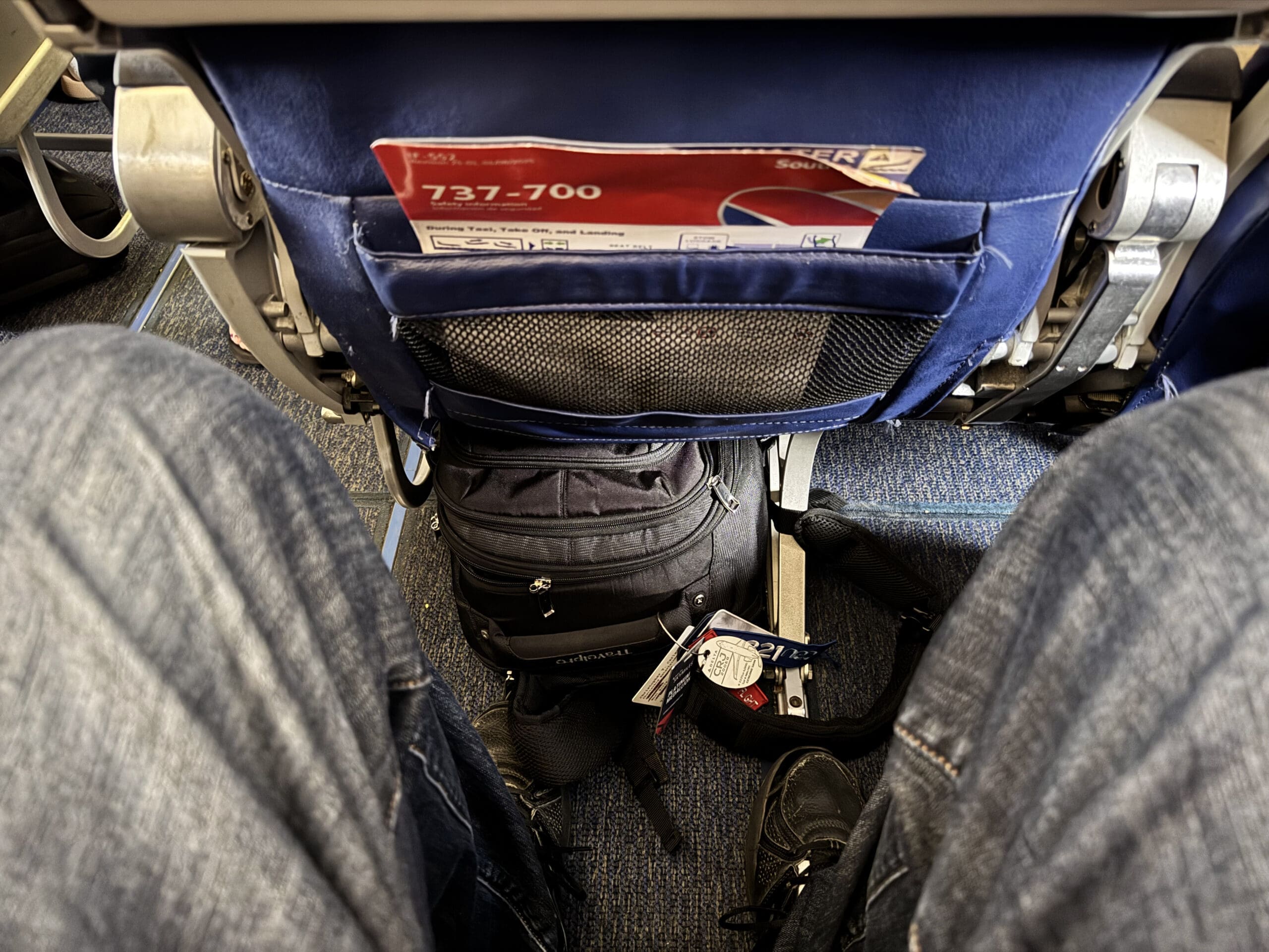 View of open floor space in front of a Southwest 737-700 Extra Legroom seat with a backpack stowed and room to spare