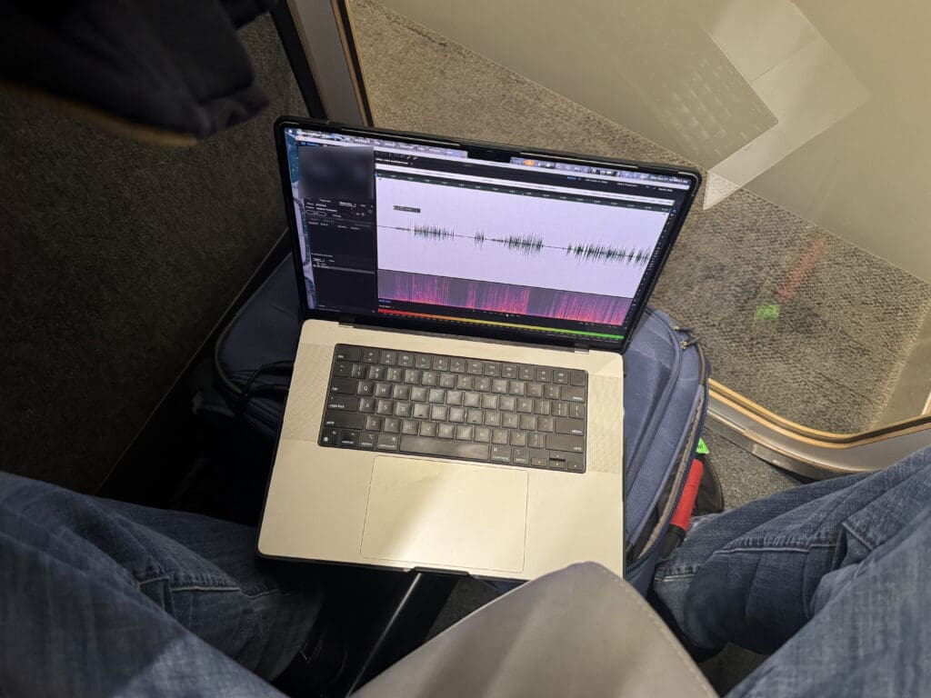 MacBook Pro with Adobe Audition recording in a Delta Sky Club phone booth