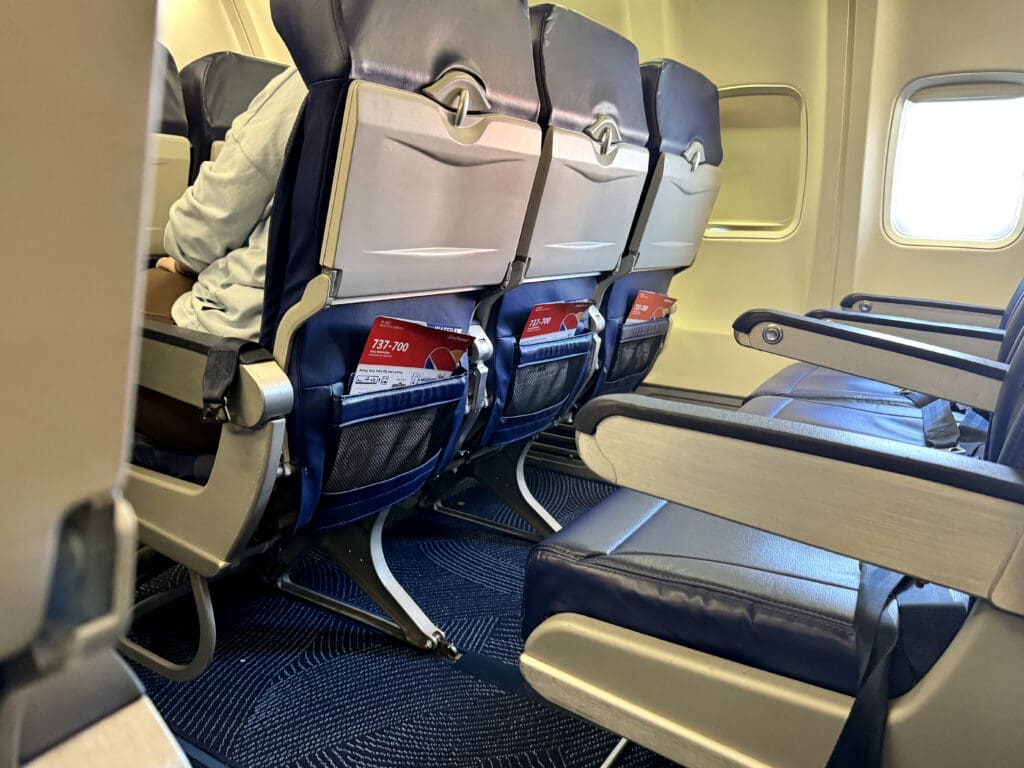 View of open floor space in front of a Southwest 737-700 Extra Legroom seat with a backpack stowed and room to spare
