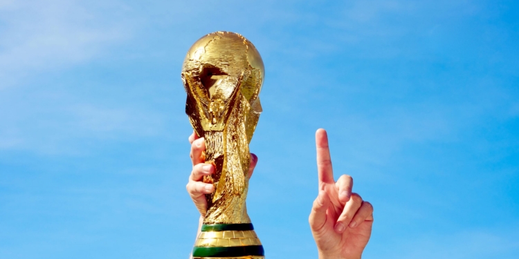 Hands holding up a replica of the Soccer World Cup previous to South Africa's Tournament