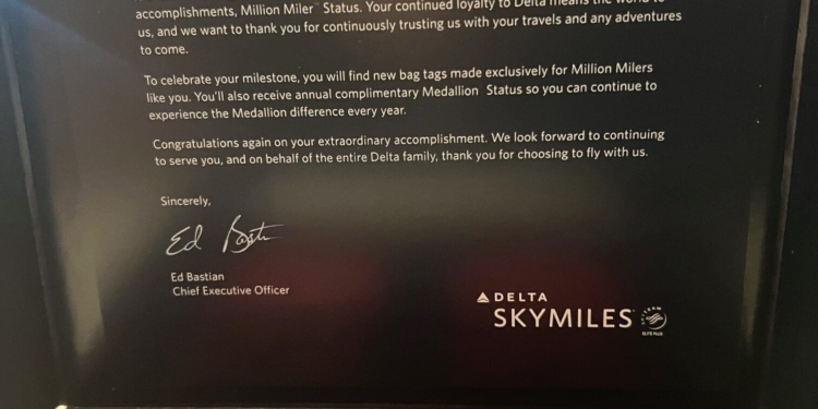 The image shows a congratulatory letter and two red bag tags from Delta Air Lines for achieving "Million Miler" status. The letter, signed by Ed Bastian, CEO of Delta, expresses gratitude for the recipient's loyalty and outlines the benefits of the status, including complimentary Medallion® Status. The bag tags are branded with "Million Miler" and "Delta SkyMiles."