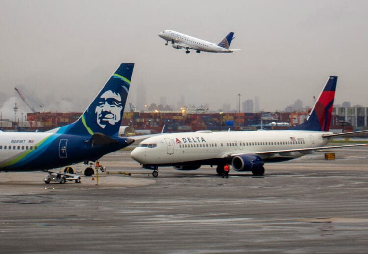Delta Air Lines Boeing 737-832 aircraft registered as N3752 being towed to gate near parked Alaska Airlines Boeing 737-9 Max aircraft N291BT at Newark Liberty International Airport in April 2022. (©iStock.com/kameraworld)